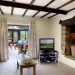 Sitting room with inglenook and log burner: logs included